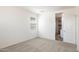 This is a bright bedroom with neutral carpet, white walls, and a window for natural light at 25235 N 183Rd Dr, Wittmann, AZ 85361