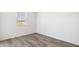 This bedroom has vinyl floors, a window, and bright walls at 25235 N 183Rd Dr, Wittmann, AZ 85361