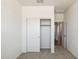 Bedroom with neutral carpet features closet with sliding doors and an open doorway at 25235 N 183Rd Dr, Wittmann, AZ 85361