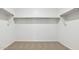 Walk-in closet with carpet flooring and shelving, ready to be personalized and organized to fit your needs at 25235 N 183Rd Dr, Wittmann, AZ 85361