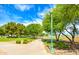 Walking path in community park, featuring mature trees and manicured landscaping at 25235 N 183Rd Dr, Wittmann, AZ 85361