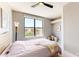 Cozy bedroom with a large window overlooking the outdoors and a stylish ceiling fan at 25555 N Windy Walk Dr # 64, Scottsdale, AZ 85255