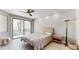 Bright bedroom featuring a ceiling fan and sliding doors to a private balcony at 25555 N Windy Walk Dr # 64, Scottsdale, AZ 85255