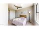 Bedroom featuring a ceiling fan, light wood flooring, and natural light from a window at 25555 N Windy Walk Dr # 64, Scottsdale, AZ 85255