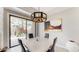 Dining area with modern lighting, a painting, and view of the lush desert landscape at 25555 N Windy Walk Dr # 64, Scottsdale, AZ 85255