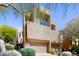 Contemporary two-story home with a two-car garage and desert landscaping under a clear sky at 25555 N Windy Walk Dr # 64, Scottsdale, AZ 85255