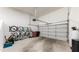 Spacious garage with an automatic door and multiple bicycle racks on the back wall at 25555 N Windy Walk Dr # 64, Scottsdale, AZ 85255