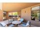 Relaxing outdoor patio with comfortable seating, a fireplace, and serene views at 25555 N Windy Walk Dr # 64, Scottsdale, AZ 85255