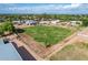 Flat, green lot with a horse on the property, nestled in a residential neighborhood at 26232 S Lemon Ave, Queen Creek, AZ 85142