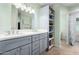 Bathroom featuring double sinks with light gray cabinets and vanity and ample shelf storage at 26232 S Lemon Ave, Queen Creek, AZ 85142