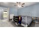 Light-filled bedroom featuring a white metal bed frame, ceiling fan, and access to the backyard at 26232 S Lemon Ave, Queen Creek, AZ 85142