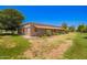 Side view of a charming ranch home with a covered porch and lush landscaping at 26232 S Lemon Ave, Queen Creek, AZ 85142