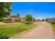 This home has a driveway, mature landscaping, and a metal storage building on a large lot at 26232 S Lemon Ave, Queen Creek, AZ 85142