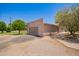 Detached garage with neutral colored exterior and roll-up doors sits among desert landscaping at 26232 S Lemon Ave, Queen Creek, AZ 85142