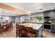 Expansive open-concept kitchen and dining area with gray cabinetry, modern appliances, and a large island for cooking and entertaining at 26232 S Lemon Ave, Queen Creek, AZ 85142