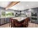 Eat-in kitchen showcasing a large center island, gray cabinets and modern stainless steel appliances at 26232 S Lemon Ave, Queen Creek, AZ 85142