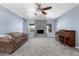 Living area with blue walls, gray brick fireplace, piano, and comfortable seating, perfect for Gathering time at 26232 S Lemon Ave, Queen Creek, AZ 85142