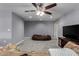 Open living area featuring comfortable seating, media center, neutral tones, and plush carpet flooring at 26232 S Lemon Ave, Queen Creek, AZ 85142