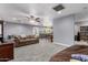 Large living room with grey walls, neutral carpet, and an open layout to the dining area at 26232 S Lemon Ave, Queen Creek, AZ 85142