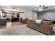 Open-concept living room with sleek gray kitchen, wood floors, and comfortable seating area, perfect for modern living at 26232 S Lemon Ave, Queen Creek, AZ 85142