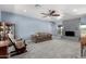 Living room with blue walls, gray brick fireplace, and carpeted floors, perfect for relaxation at 26232 S Lemon Ave, Queen Creek, AZ 85142
