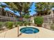 Community hot tub surrounded by a white fence, lush landscaping, and neighboring buildings at 2929 W Yorkshire Dr # 2074, Phoenix, AZ 85027