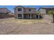 A spacious backyard featuring desert landscaping with a grass area, patio, and neighboring houses at 3018 W Horsham Dr, Phoenix, AZ 85027