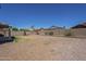 Backyard showcasing desert landscaping, partial green space, block wall, and neighboring houses at 3018 W Horsham Dr, Phoenix, AZ 85027