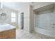 Bright bathroom features tiled floor, tub-shower, vanity and natural light at 3018 W Horsham Dr, Phoenix, AZ 85027