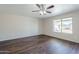 Bedroom featuring ceiling fan, large window, and modern flooring at 3018 W Horsham Dr, Phoenix, AZ 85027