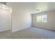 Bright bedroom featuring neutral walls, carpet flooring, and a window offering outdoor views at 3018 W Horsham Dr, Phoenix, AZ 85027