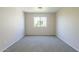 Bright bedroom featuring neutral walls, carpet flooring, and a window offering outdoor views at 3018 W Horsham Dr, Phoenix, AZ 85027