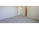 View of the bedroom featuring neutral walls, carpet flooring, closet, and entrance to another room at 3018 W Horsham Dr, Phoenix, AZ 85027