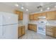 Well-lit kitchen with tile floors, bright white appliances, and wooden cabinetry at 3018 W Horsham Dr, Phoenix, AZ 85027