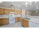 Bright eat-in kitchen with white appliances, tile flooring, and a breakfast bar at 3018 W Horsham Dr, Phoenix, AZ 85027