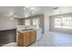 Bright living room featuring tile flooring and breakfast bar overlooking the kitchen at 3018 W Horsham Dr, Phoenix, AZ 85027