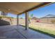 Covered patio area featuring a concrete floor and view of the backyard and block wall at 3018 W Horsham Dr, Phoenix, AZ 85027