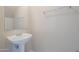 Pedestal sink in well-lit half bathroom with mirror and towel bar at 3018 W Horsham Dr, Phoenix, AZ 85027