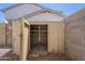 Backyard shed with storage shelves adjacent to a block wall at 3018 W Horsham Dr, Phoenix, AZ 85027