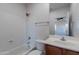 Bright bathroom features a shower-tub combo, modern vanity, and a large mirror at 30277 N 125Th Ln, Peoria, AZ 85383