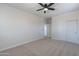 This bedroom offers neutral carpet, ceiling fan, and a closet with sliding doors at 30277 N 125Th Ln, Peoria, AZ 85383