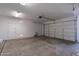 Spacious garage with an automatic door, additional door, and concrete flooring at 30277 N 125Th Ln, Peoria, AZ 85383