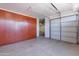 Garage with built-in storage cabinets, automatic garage door, and concrete floors at 30277 N 125Th Ln, Peoria, AZ 85383