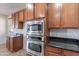 A kitchen with stainless steel appliances and wood cabinets at 30277 N 125Th Ln, Peoria, AZ 85383