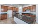 Kitchen featuring granite island with sink, stainless steel appliances, and tile flooring at 30277 N 125Th Ln, Peoria, AZ 85383