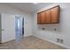 This laundry room has wood cabinets at 30277 N 125Th Ln, Peoria, AZ 85383