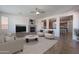 Inviting living room with fireplace, modern furniture, and an open view to the kitchen and breakfast bar at 30277 N 125Th Ln, Peoria, AZ 85383