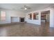 Living room with fireplace and view of the kitchen area with modern appliances at 30277 N 125Th Ln, Peoria, AZ 85383