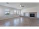 Open living room design with decorative fireplace, tile floors and plenty of natural light at 30277 N 125Th Ln, Peoria, AZ 85383