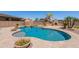 Inviting backyard features a gorgeous pool, spa, landscaping, and a block fence at 30277 N 125Th Ln, Peoria, AZ 85383